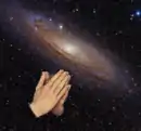 Praying hands with Andromeda Galaxy
